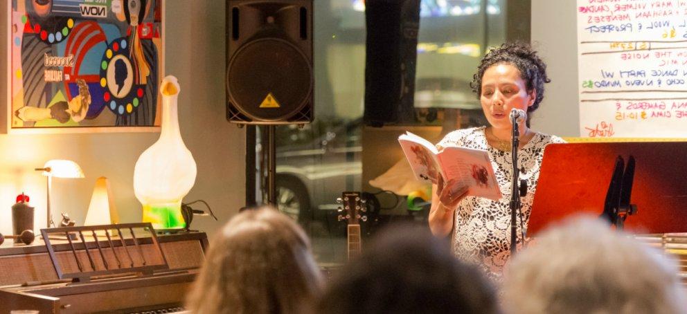 An MFA student reads to an audience.